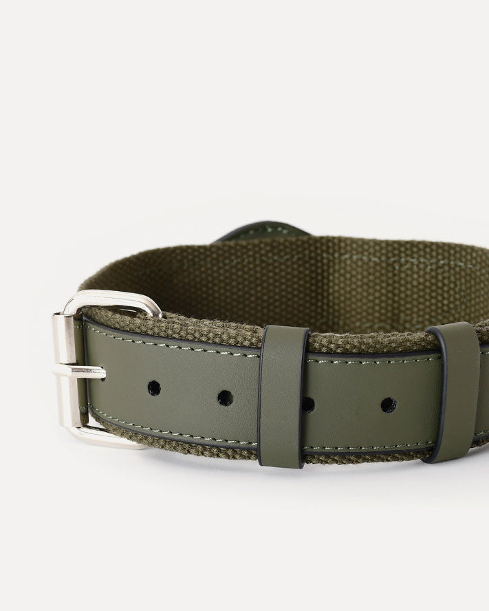 Close-up of the moss green airtag dog collar, featuring a sleek leather exterior, soft nylon interior for comfort and durability, and adjustable holes to fit dogs of various sizes.