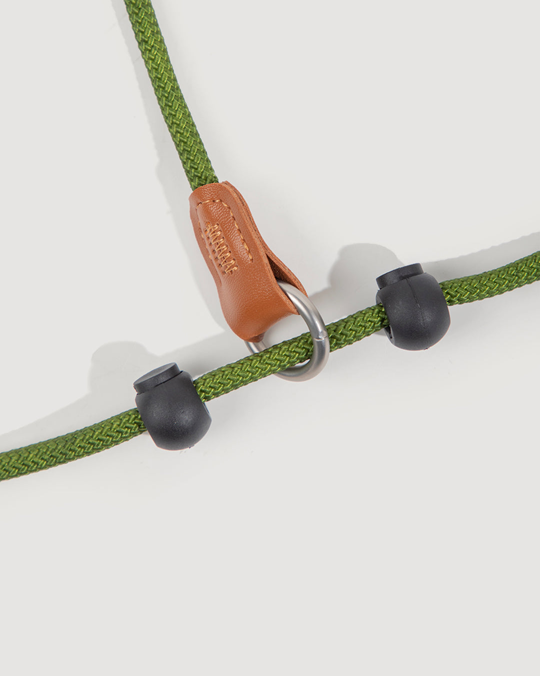 Close-up of the moss green dog slip lead, highlighting the black plastic adjusters.