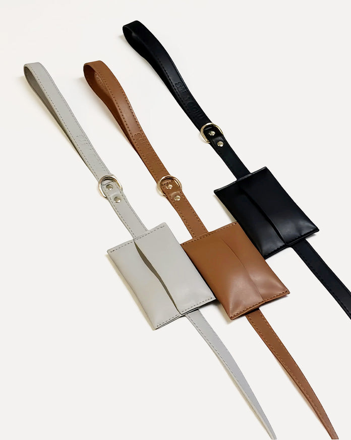 Overview of gray, brown, and black waterproof leather dog leashes with waste bag holders.