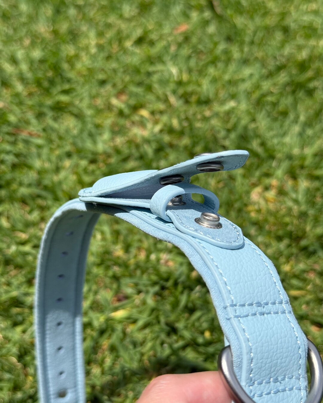Close-up of waterproof AirTag dog collar showing built-in AirTag holder with secure snap closure.