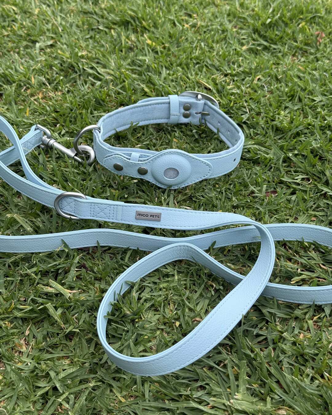 Waterproof AirTag dog collar and leash set laid flat on grass