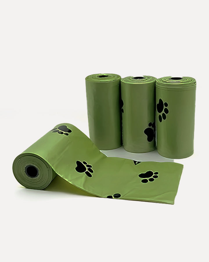 Detail view of biodegradable dog poop bags in green, showcasing the paw print design.