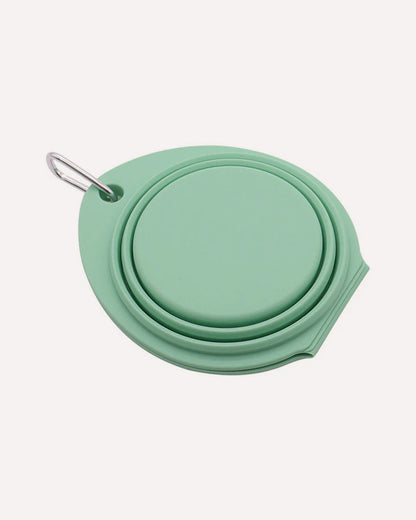 Folded collapsible travel double dog bowl in cyan, featuring a compact design.
