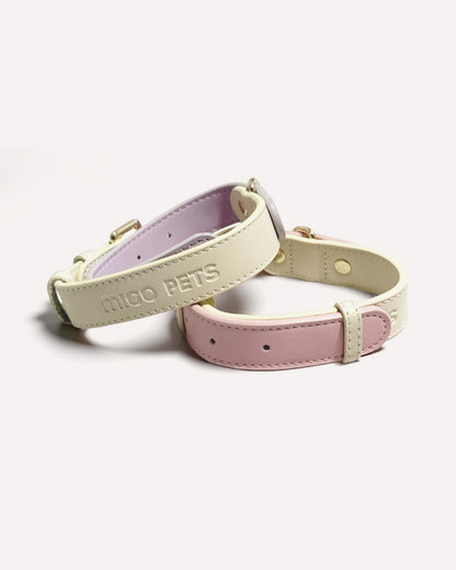 Close-up of two-tone genuine leather dog collars in pink and violet purple.