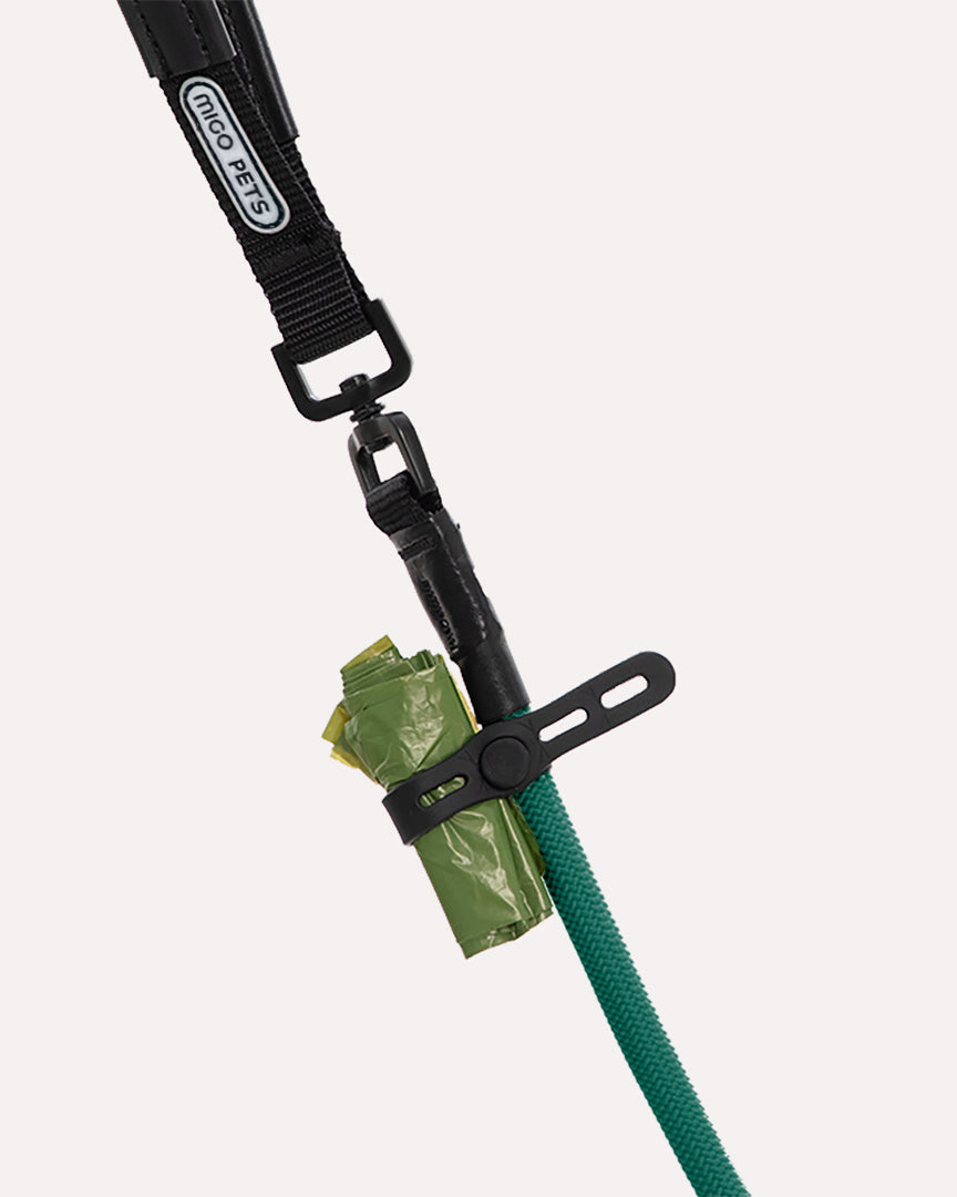 Close-up of the dark green heavy duty dog slip lead, highlighting the feature of attaching waste bags to the leash.