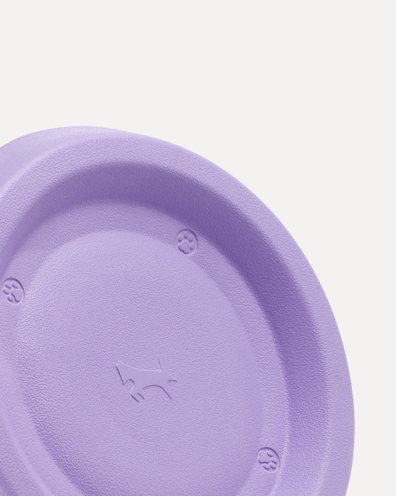 Close-up of the purple soft floating, easy-to-clean dog frisbee, highlighting its soft, gum-friendly design.