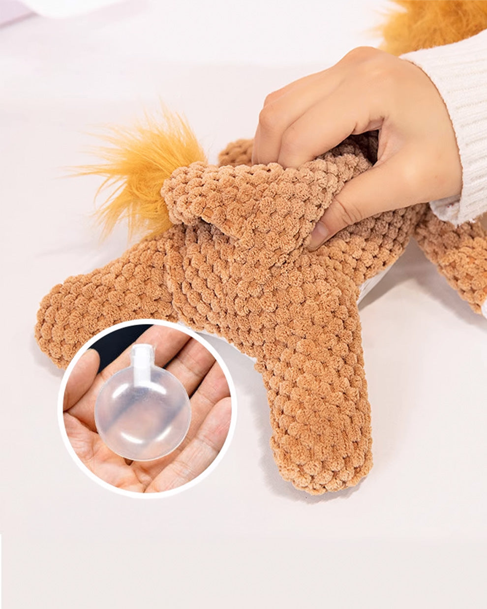 Close-up of the lion plush dog toy showing the texture and built-in squeaker feature.