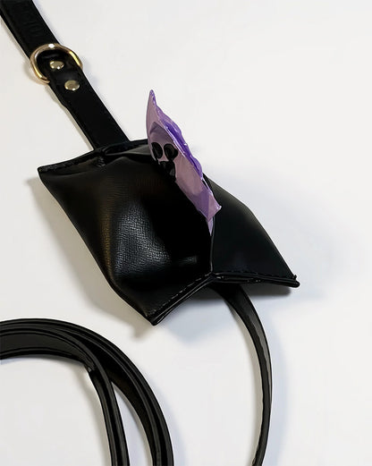 Close-up of black waterproof leather dog leash with attached waste bag. holder.